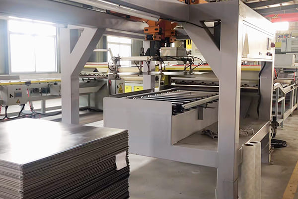 alt text: Factory workers optimizing an LVT flooring production line