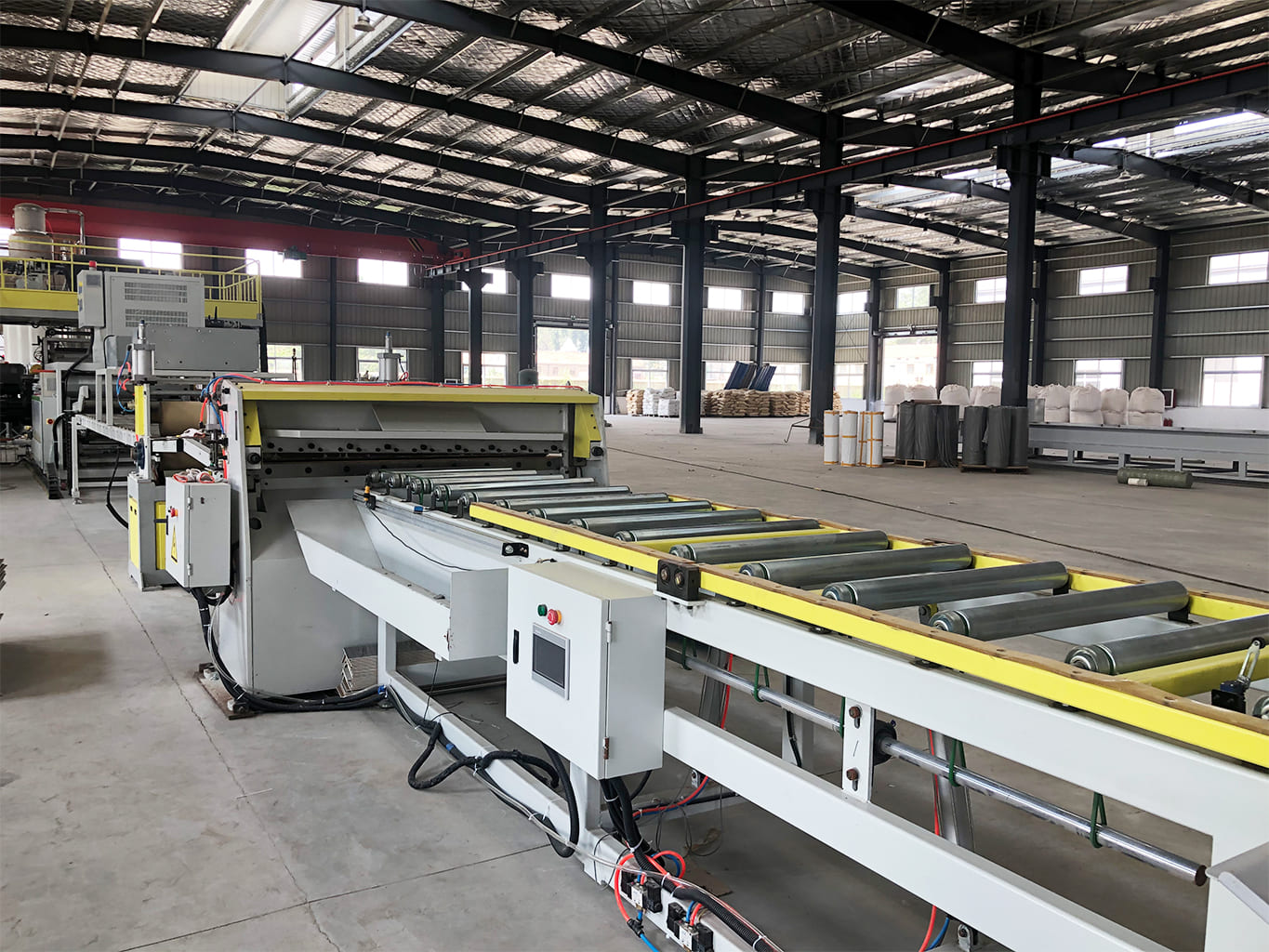 Interior view of a large-scale flooring factory production line