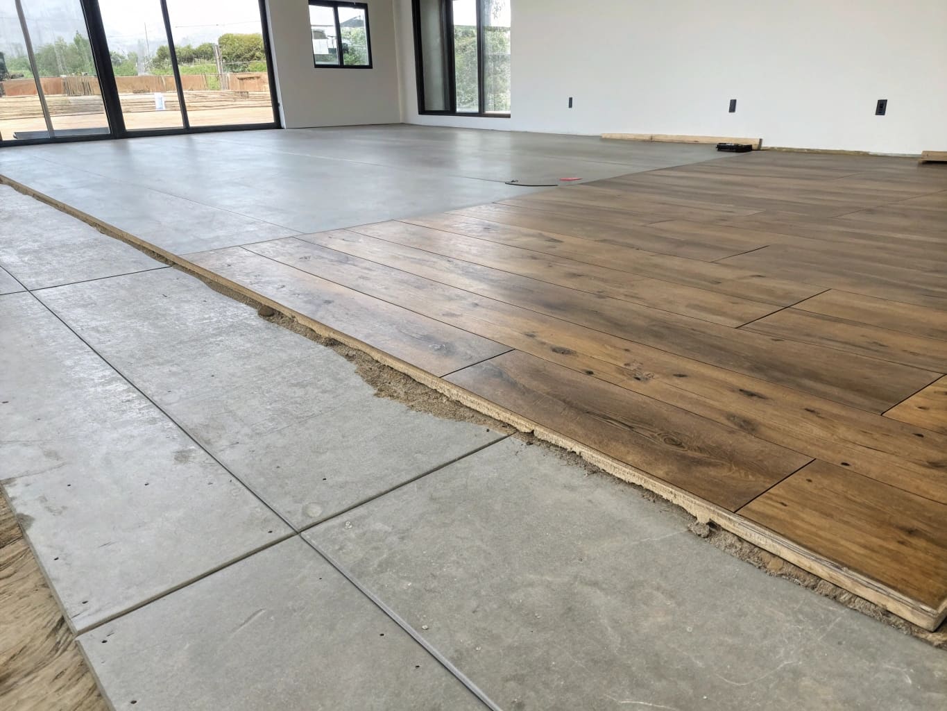 SPC flooring installation over concrete slab, wood-look planks